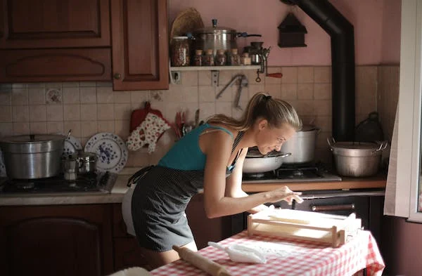 a lady making a snack on the table